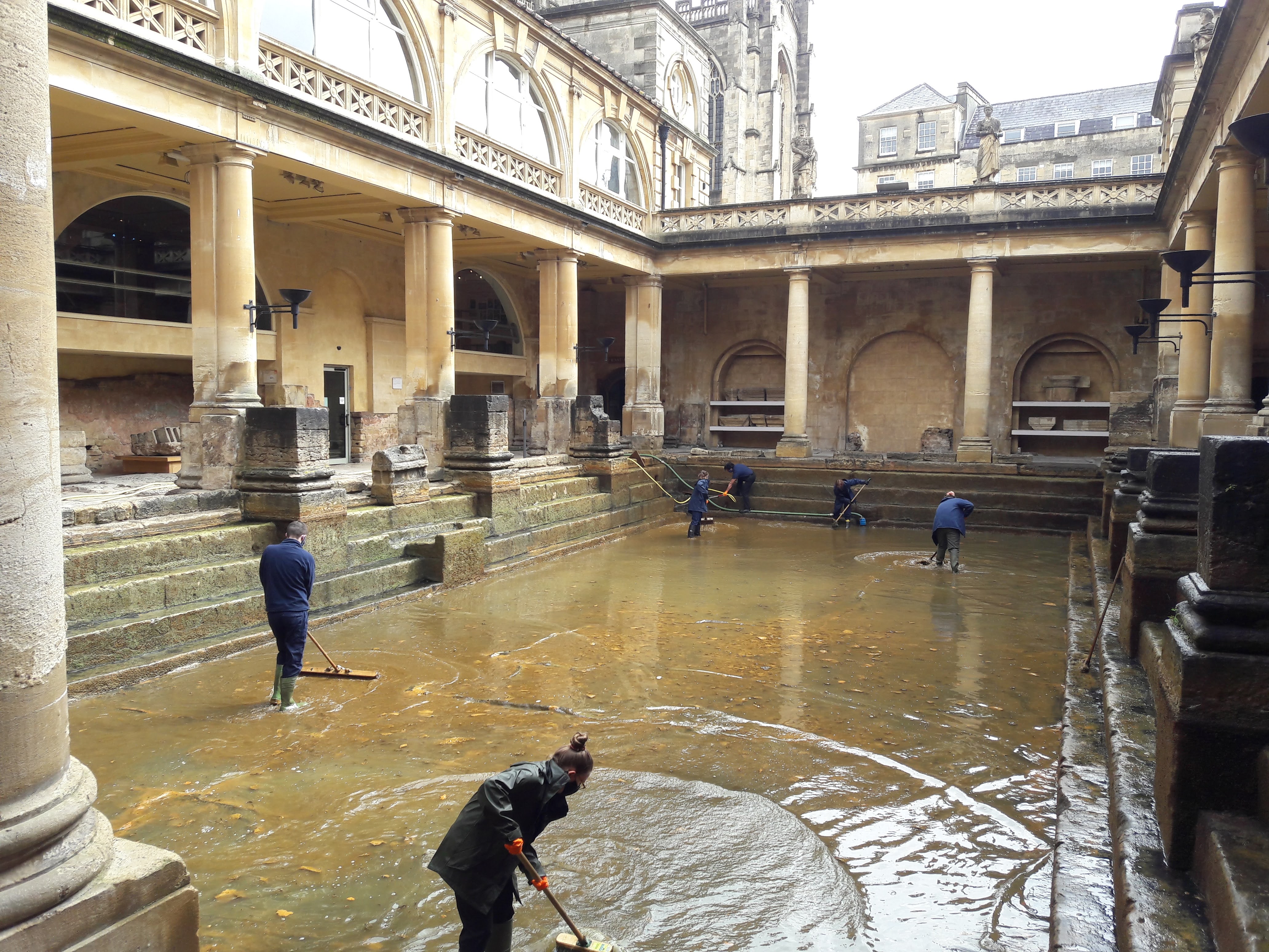 Image: Operations staff cleaning the Great Bath