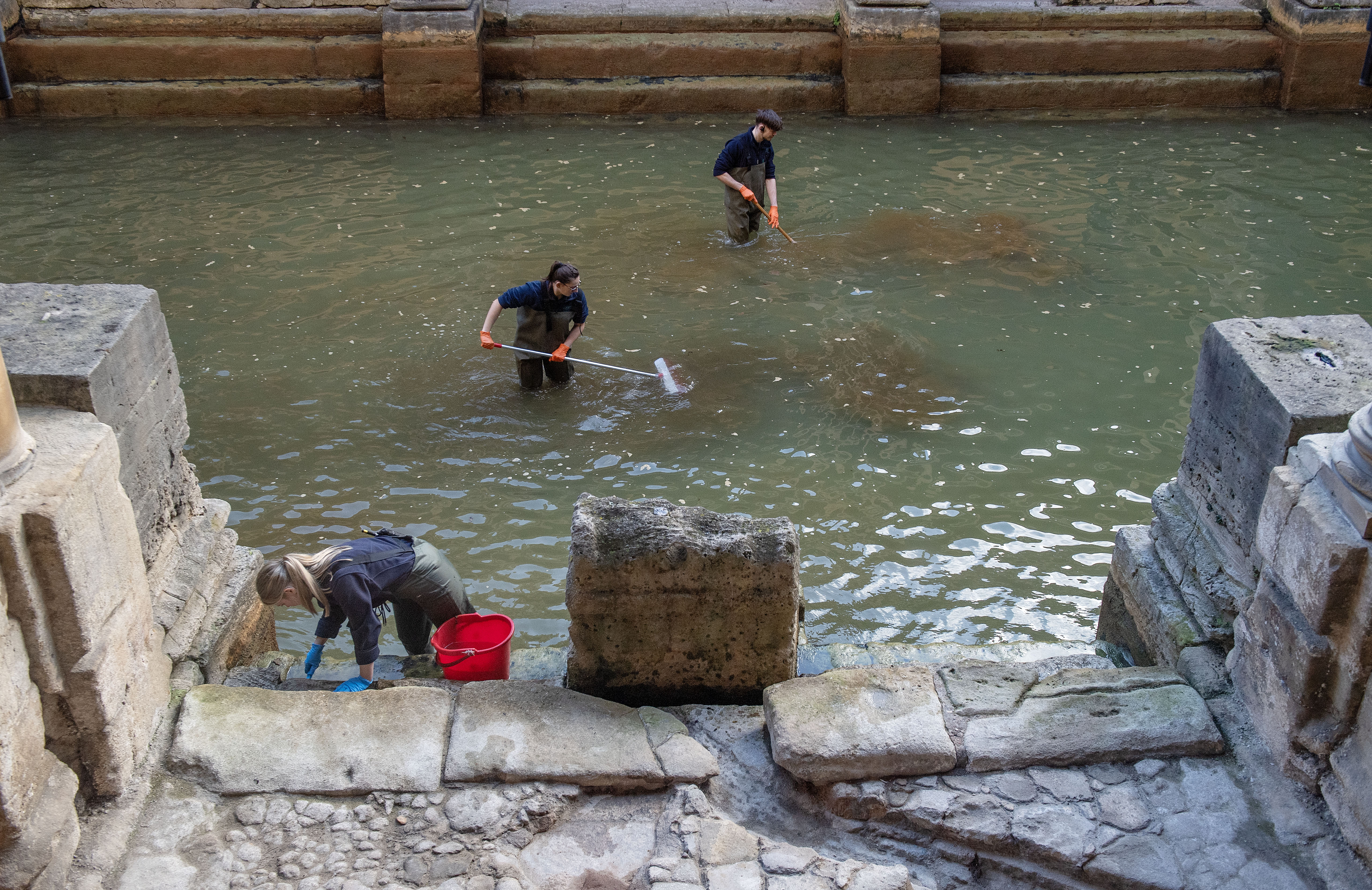 Image: The Operations team are in the Great Bath and sweeping away the algae