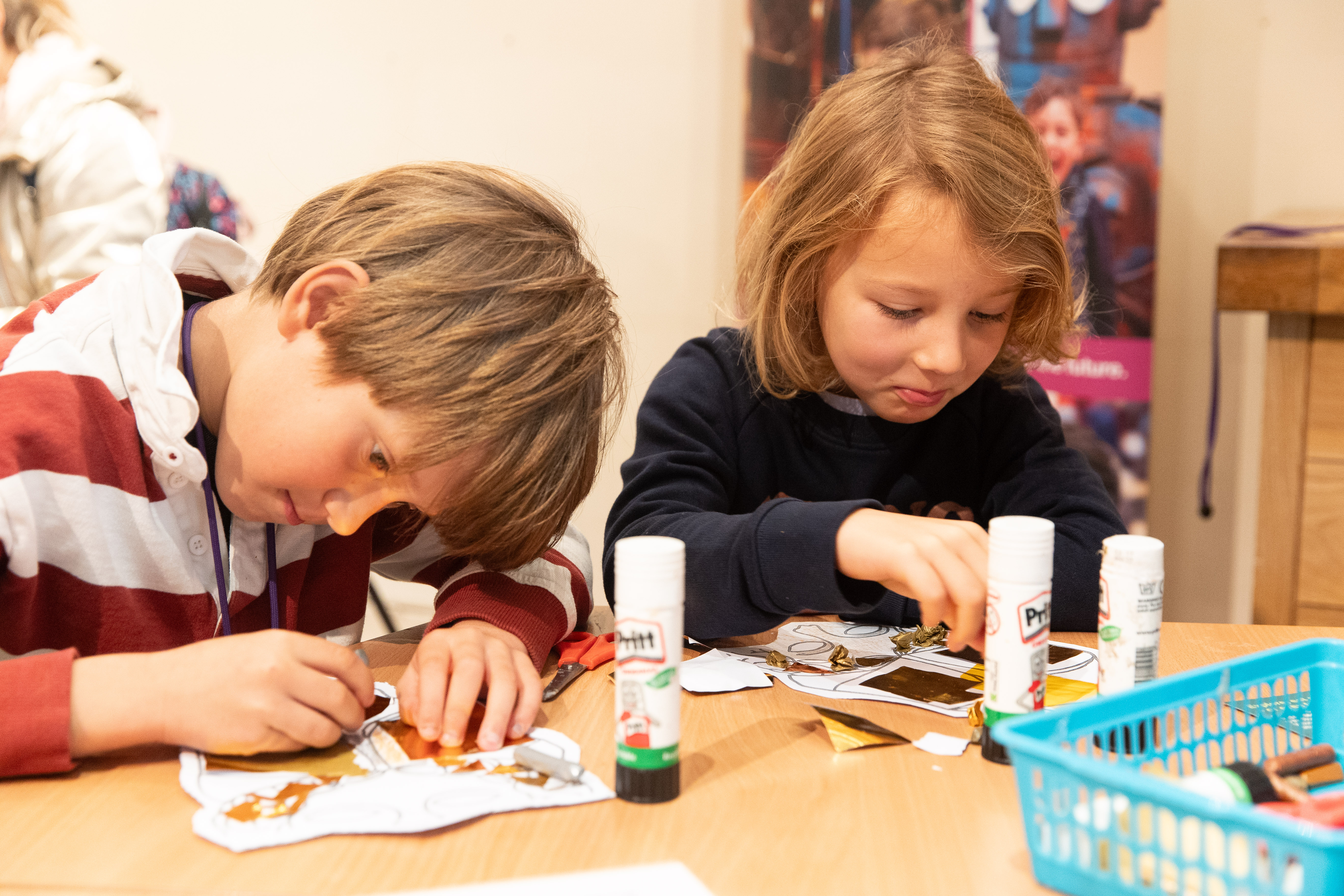 a young boy and girl doing arts and crafts