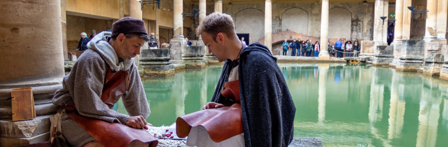 Roman Characters sat by the Great Bath