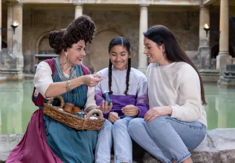 Image: Visitors interacting with a costumed character