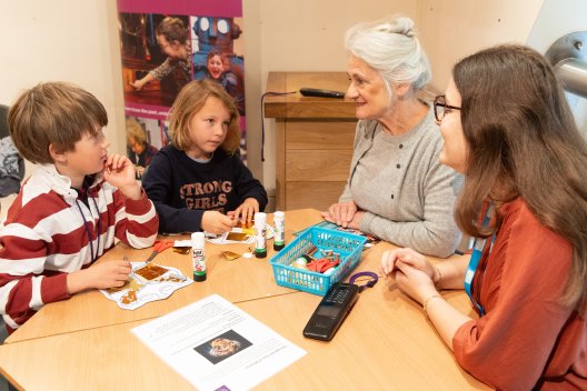 Two children doing crafts at Roman Baths