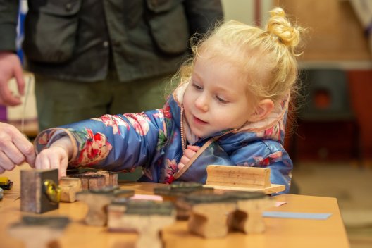 Child doing crafts at The Roman Baths